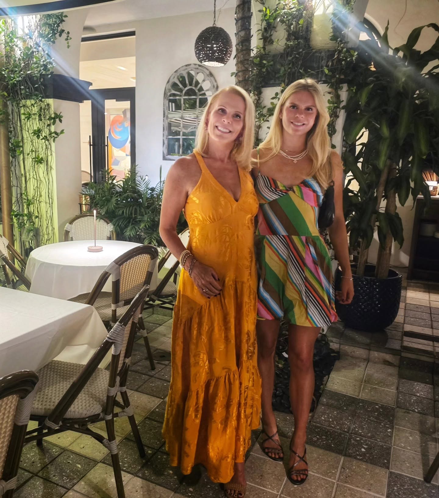 Two friends dressed up for dinner on the terrace