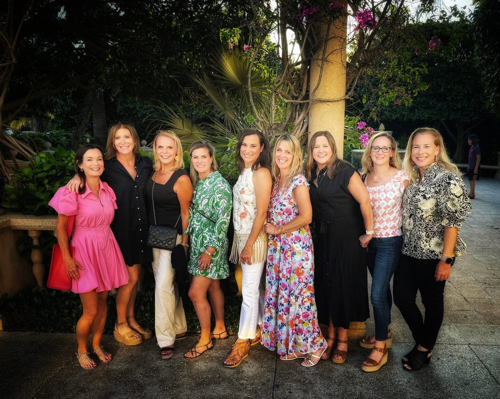 The Magnolias gathered under the bougainvillea in evening dresses