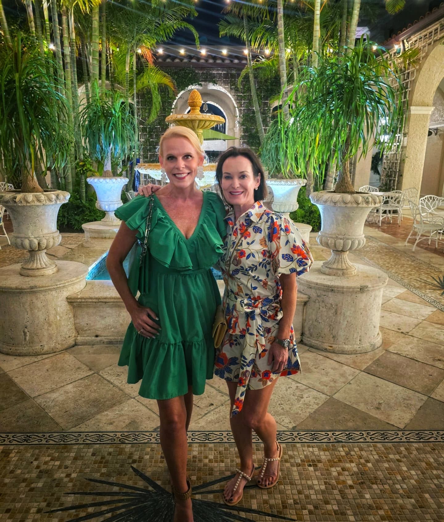 Two best friends in front of the fountain at night